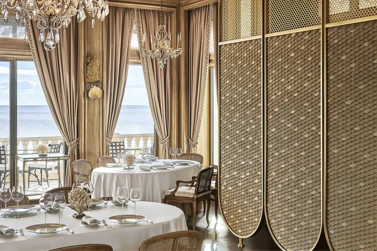 Intimate dining alcove with individual tables and Mediterranean views