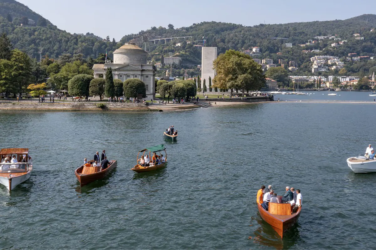 Lakeside view of the palazzo and surrounding hills during golden hour