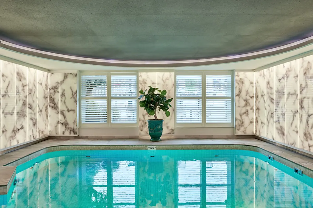 Spa hallway with warm wood accents and natural light from clerestory windows