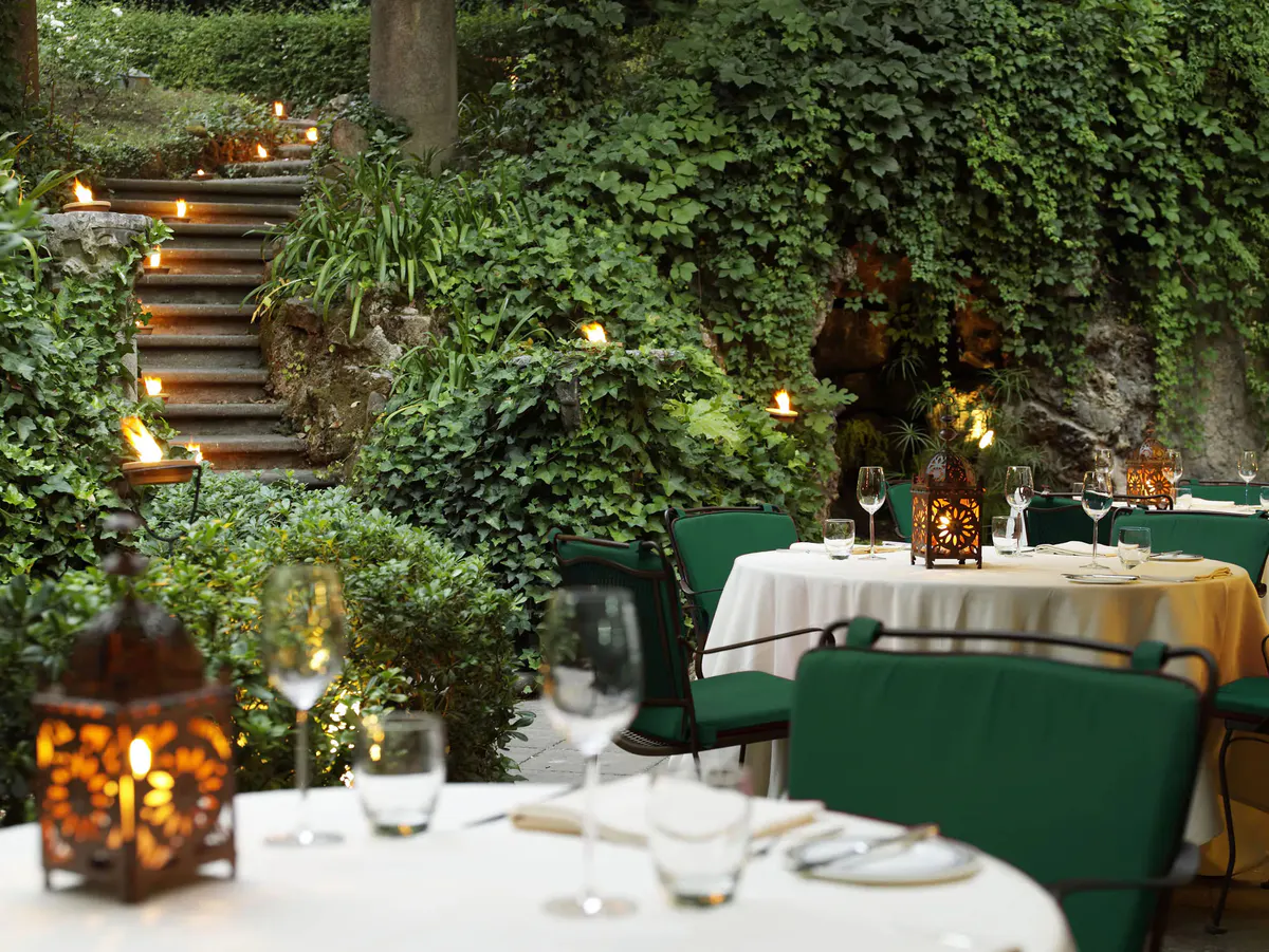 Terraced garden dining area with ivy-covered walls and layered seating