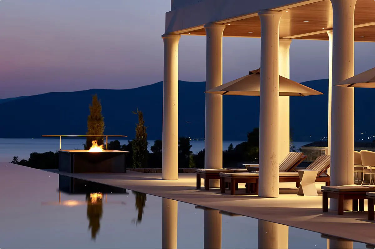 Infinity pool at dusk with columned structure and Aegean views