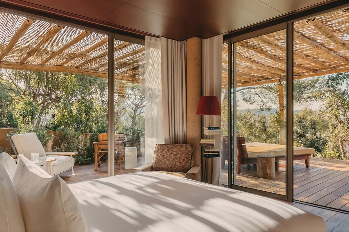 Bedroom with timber ceiling, glass doors, and panoramic landscape view