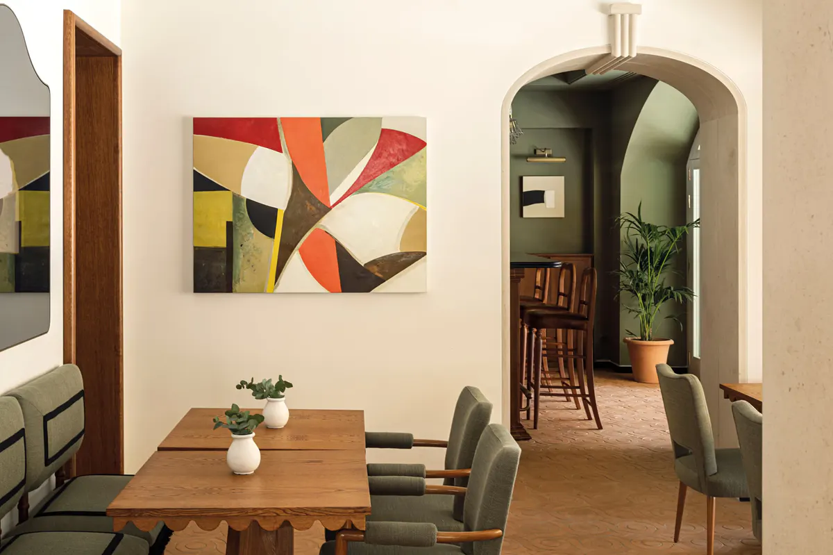 Dining room with geometric wall art and multiple seating areas