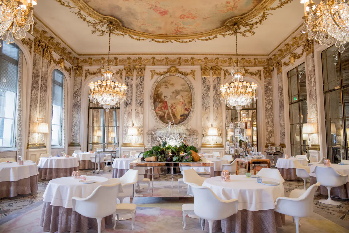 The grand dining room with ornate frescoed ceiling, classical proportions, and formal table settings