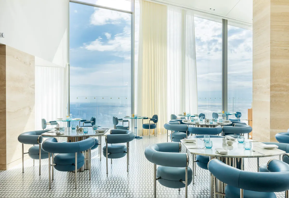 Fine dining restaurant with blue seating and Mediterranean vistas