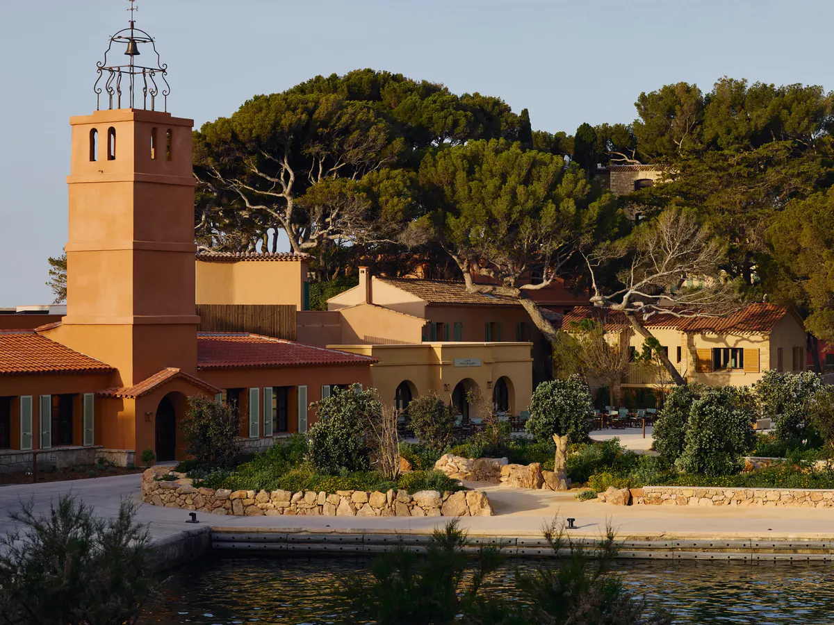 The terracotta bell tower and Café Paul Ricard rise above the harbor among umbrella pines