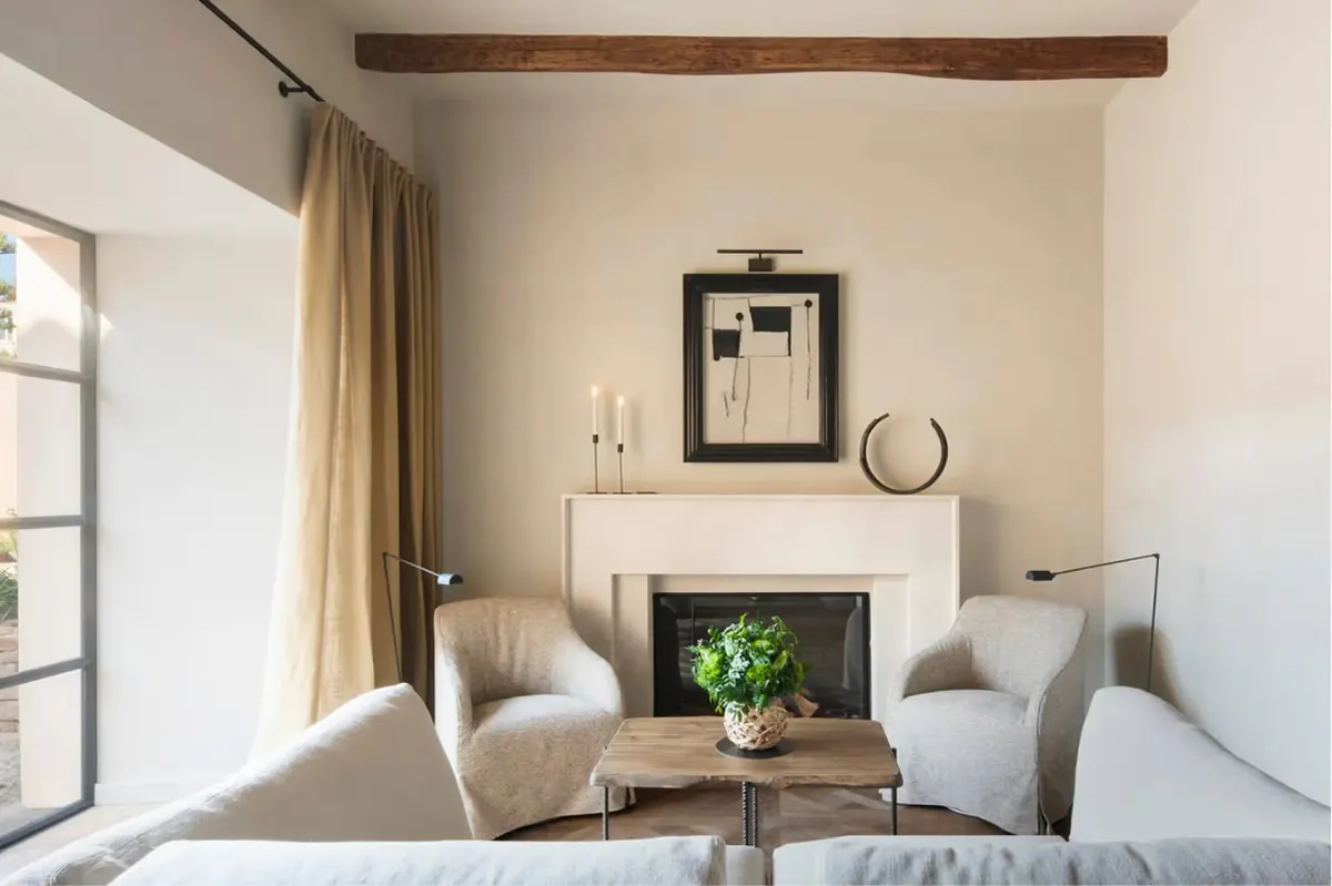 Living room seating area with fireplace and wooden ceiling beams
