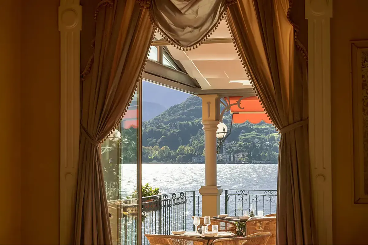 Dining alcove with draped curtains and lake-view beyond