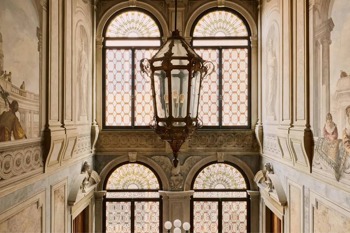 Classical arched windows with columns and lanterns in the palazzo interior courtyard