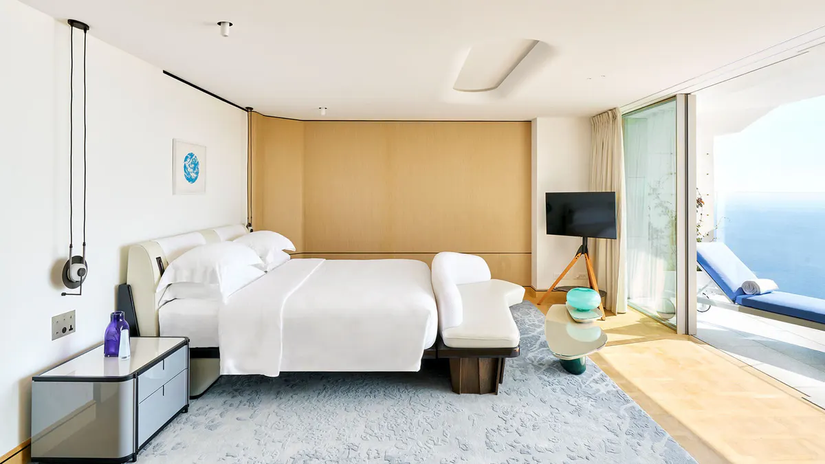 Bedroom with natural wood accents and sea views