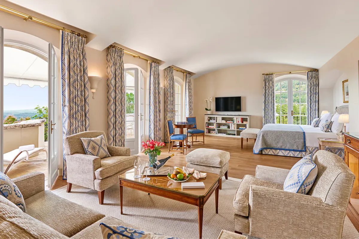 Suite living room with drapes, fireplace, and panoramic windows