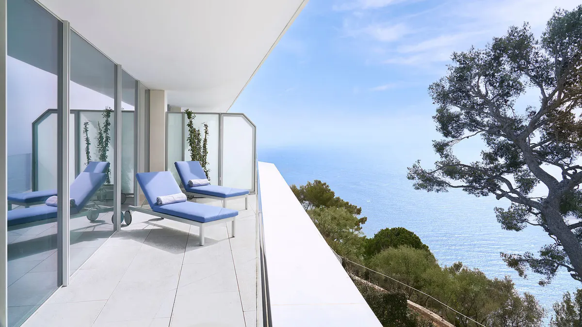 Balcony with two lounge chairs overlooking Mediterranean