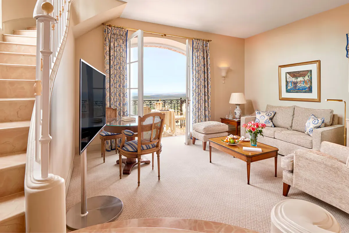 Suite bedroom with access to a living area and terrace views