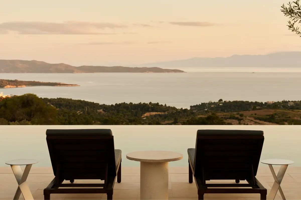 Sheltered pavilion lounge with umbrellas and wraparound sea vistas