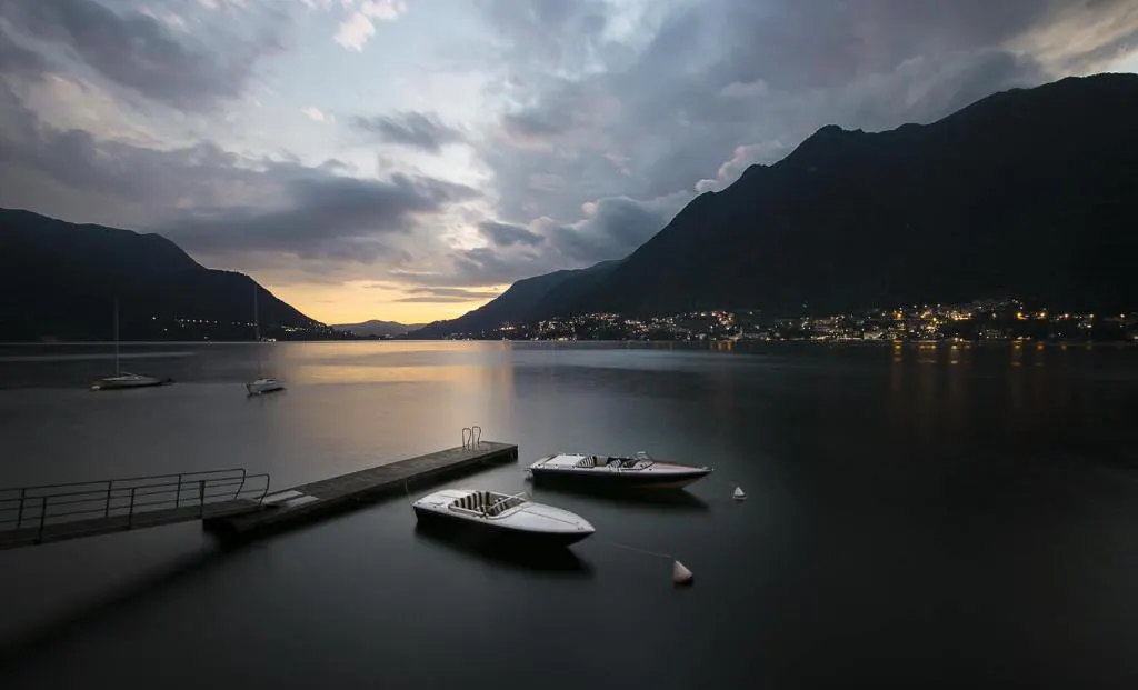 Twilight view of infinity pool overlooking the lake