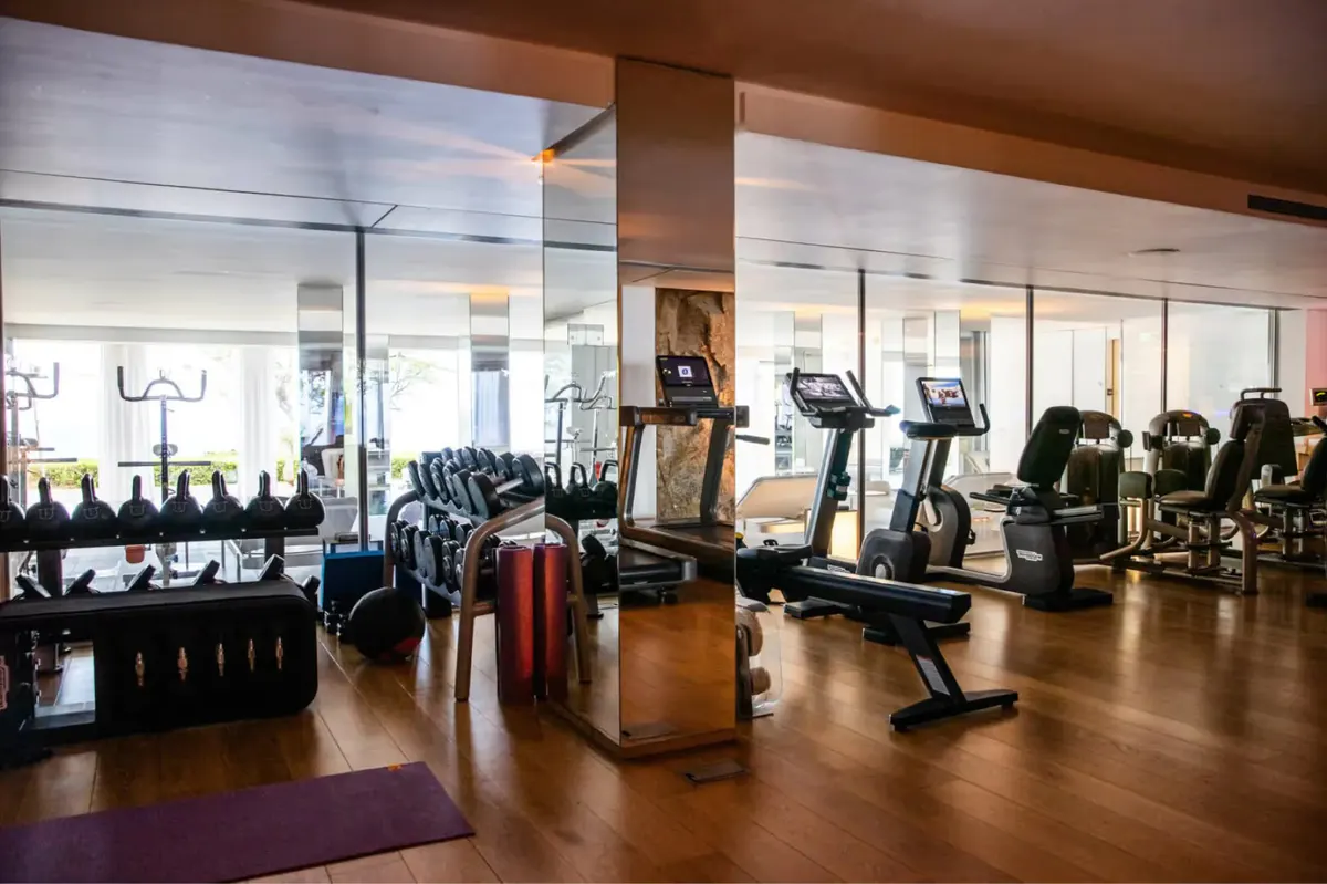 Fitness center with cardio equipment and wall of windows