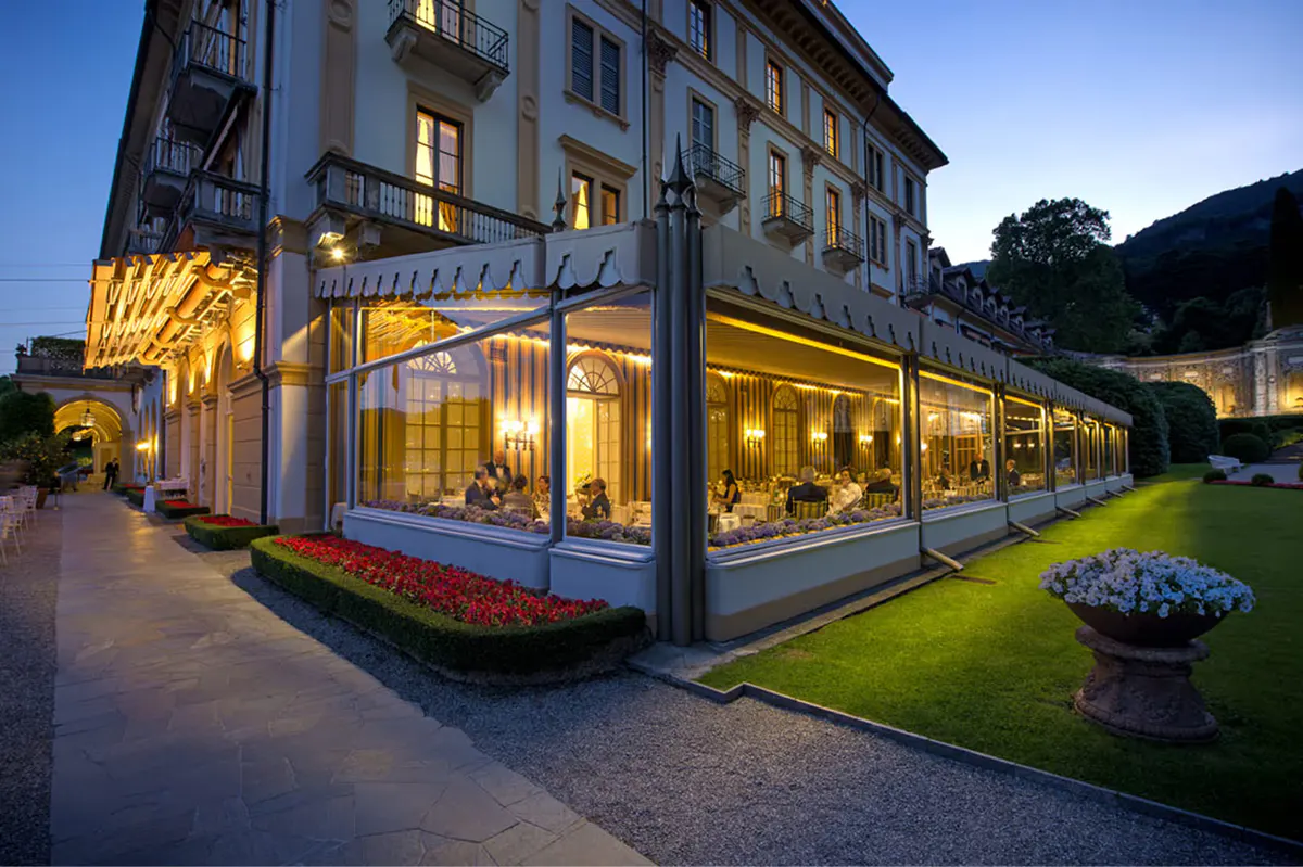 Evening outdoor terrace dining overlooking the illuminated lake