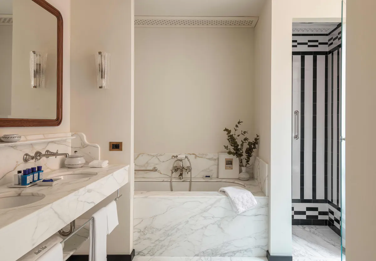 Bathroom with marble sink and black accent wall