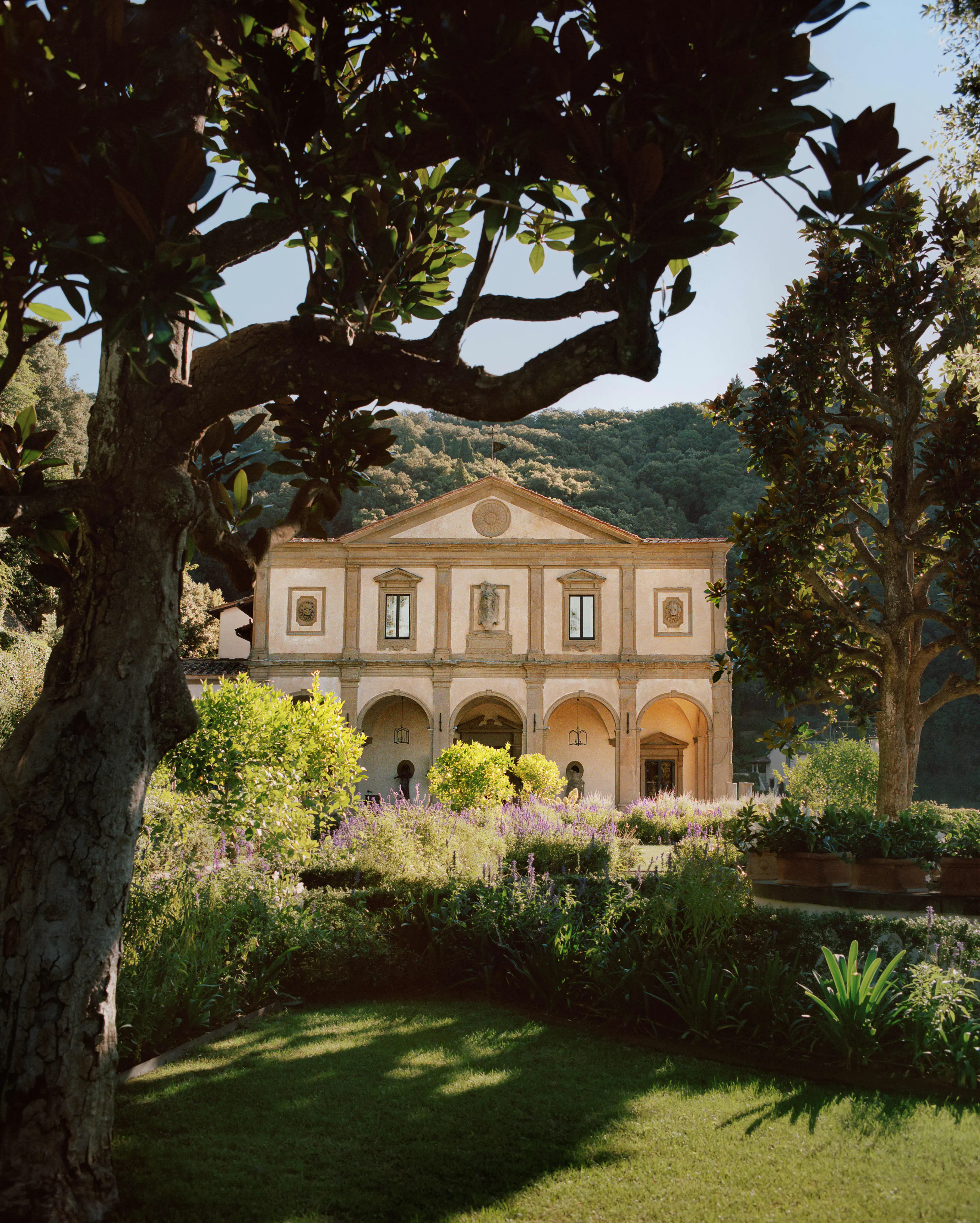 A Renaissance villa framed by trees above Florence