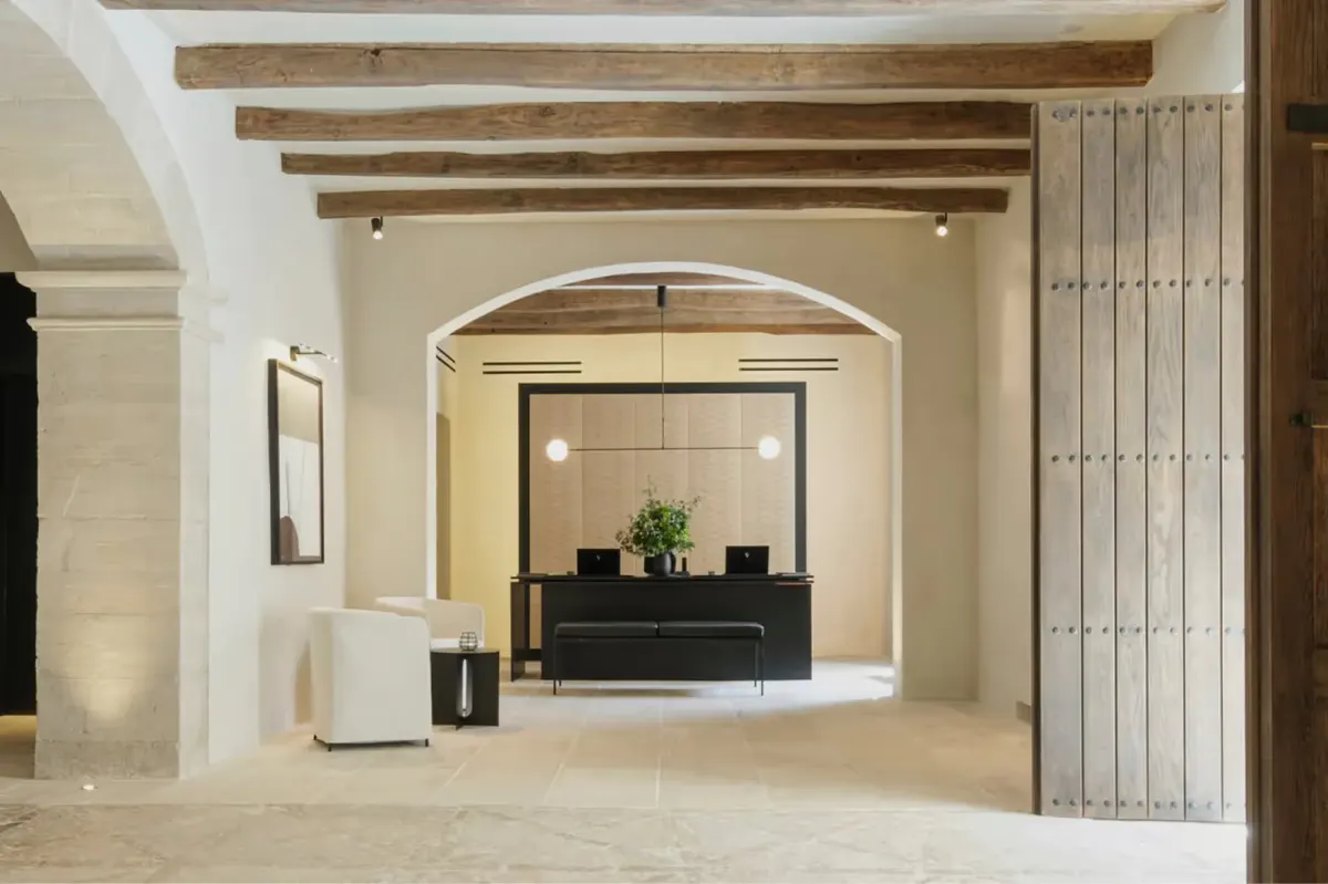 Interior archways with wooden beams framing view through multiple rooms