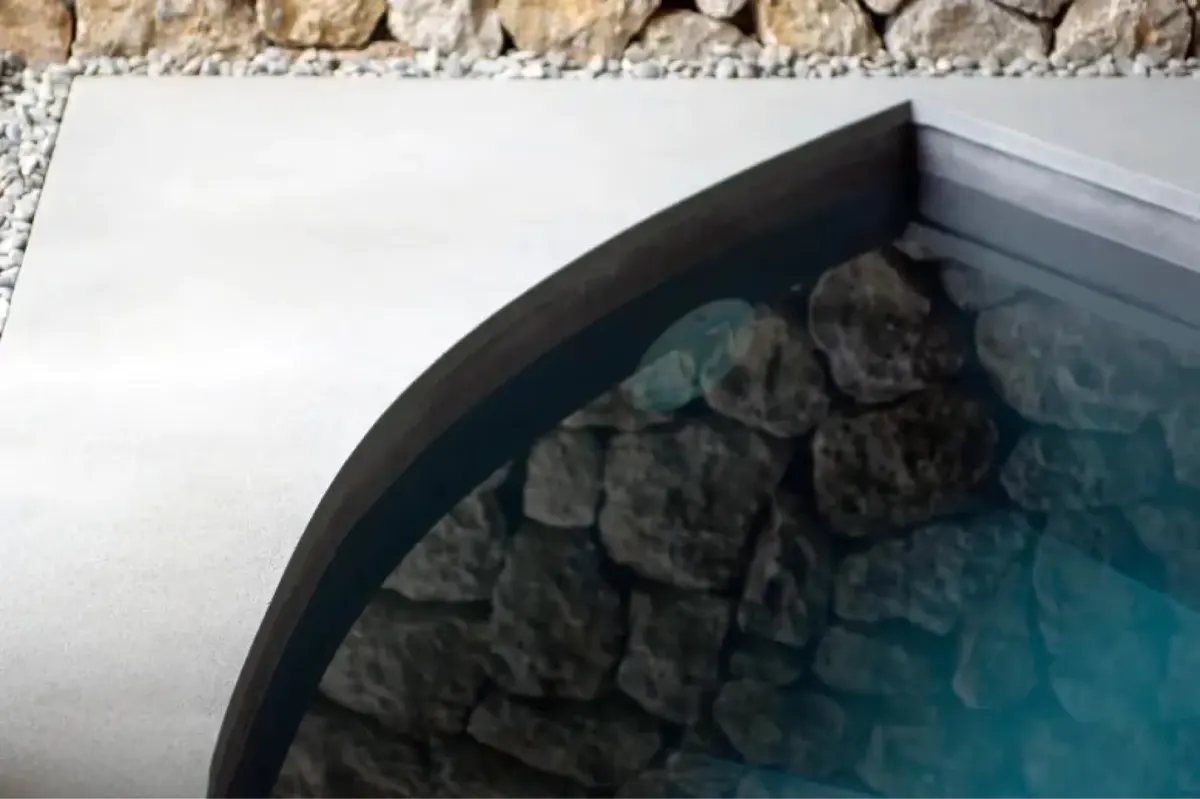 Saltwater pool edge with natural stone features and turquoise water