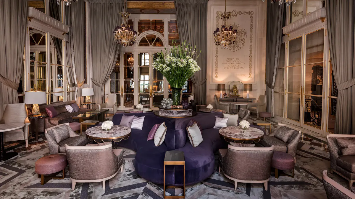 Formal dining table in dark room with decorative ceiling and candlelit ambiance