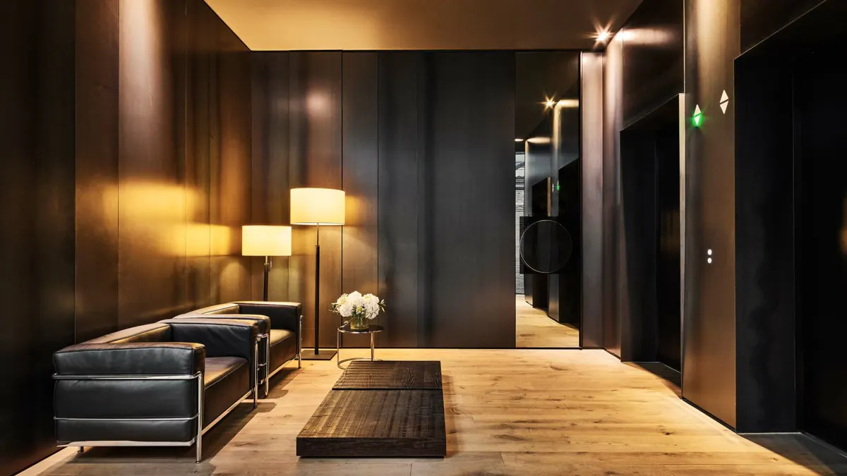 Contemporary entrance hall with dark timber accents, pendant lighting, and polished wood flooring