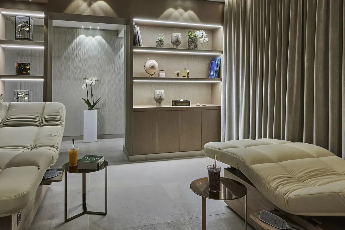 Spa relaxation lounge with cream seating and built-in shelving