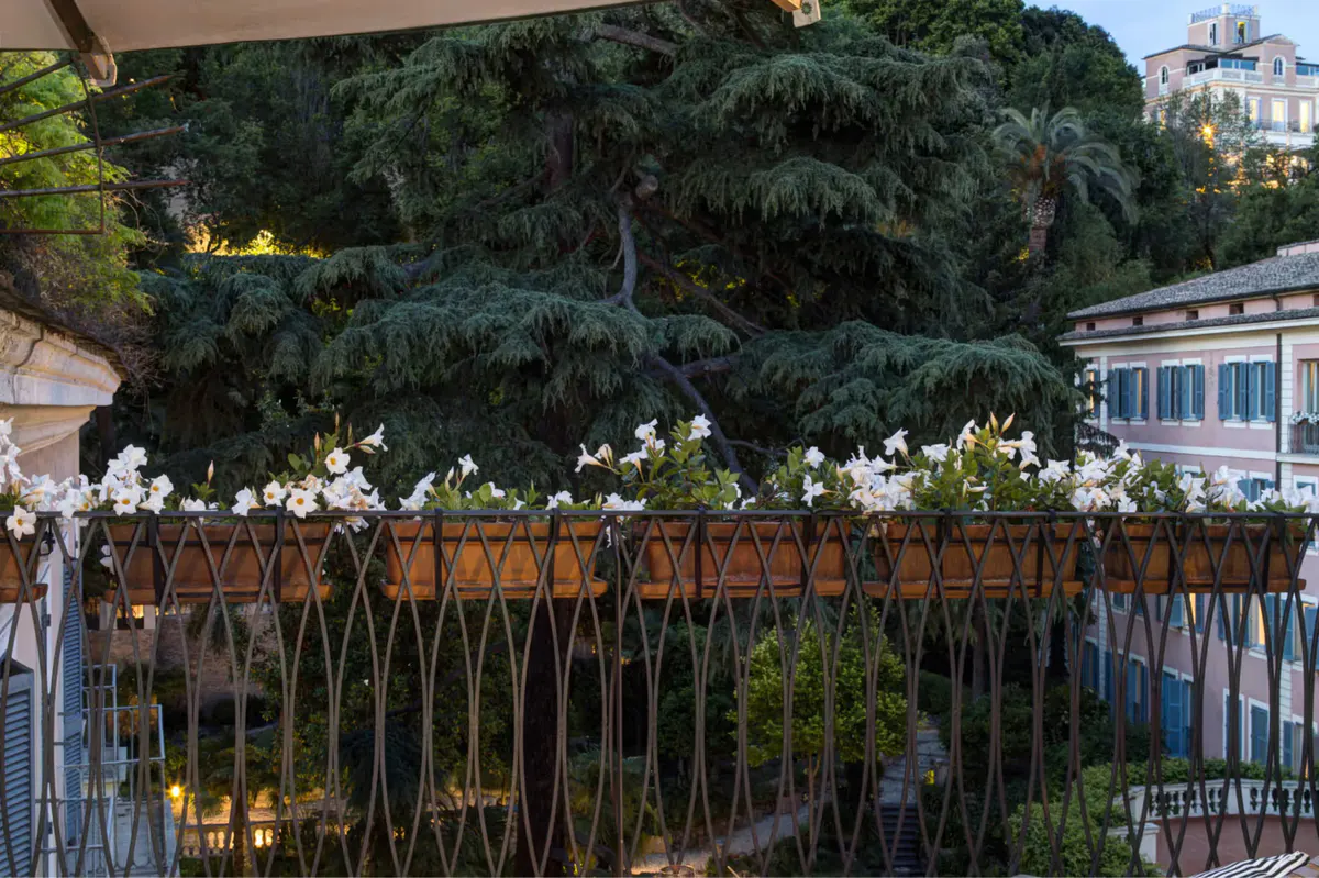 Rooftop terrace with garden planters and city buildings beyond