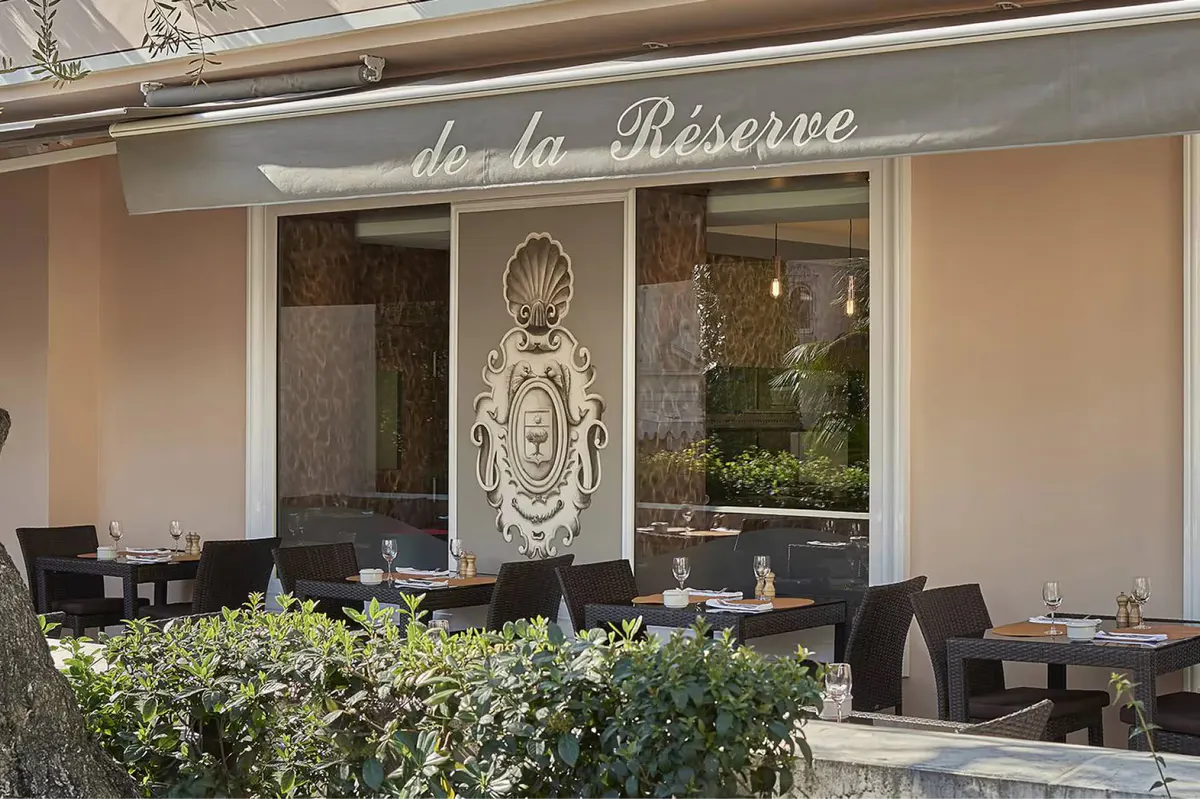 Restaurant storefront with signage and outdoor seating area