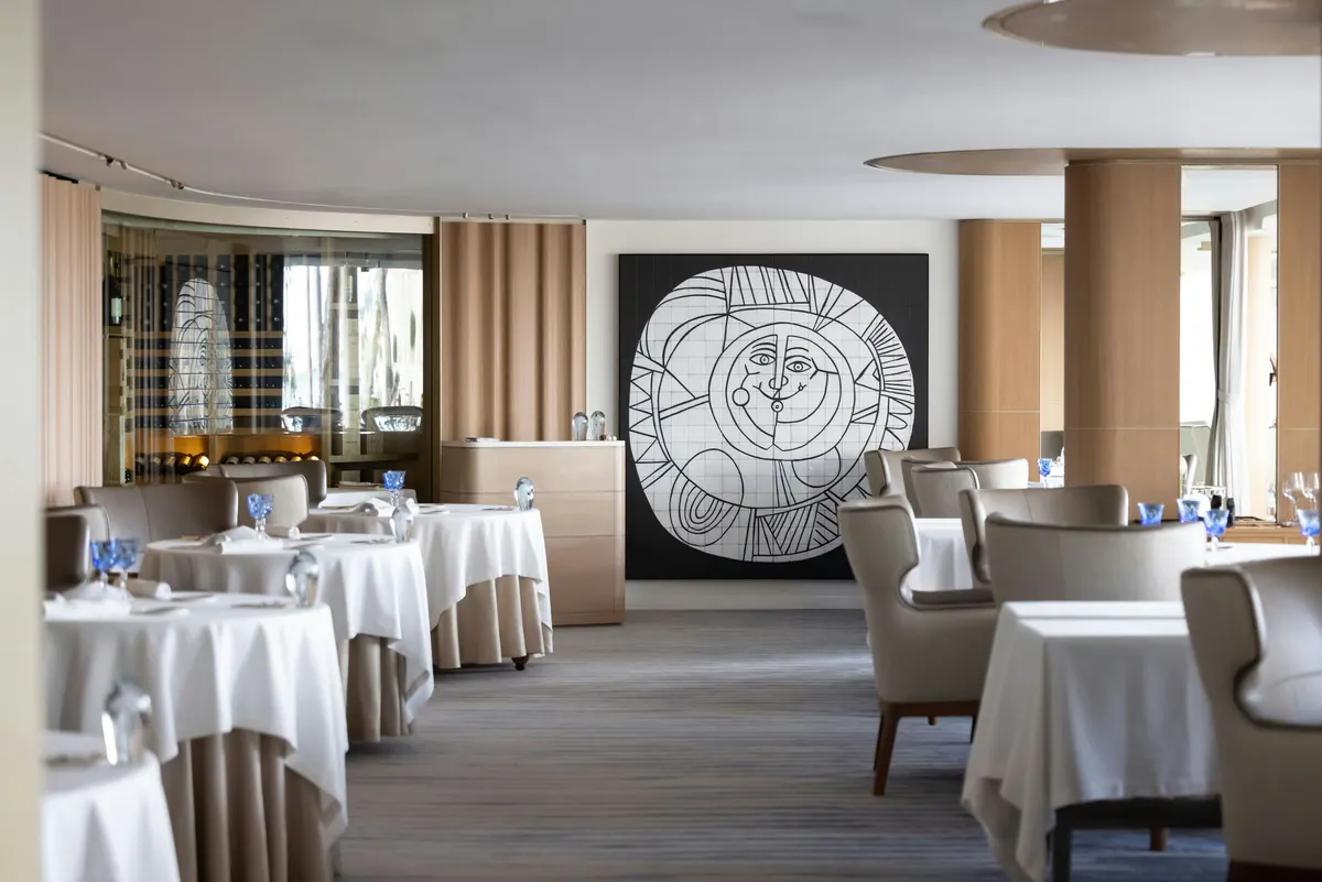Fine dining room with pendant lights and modern artwork