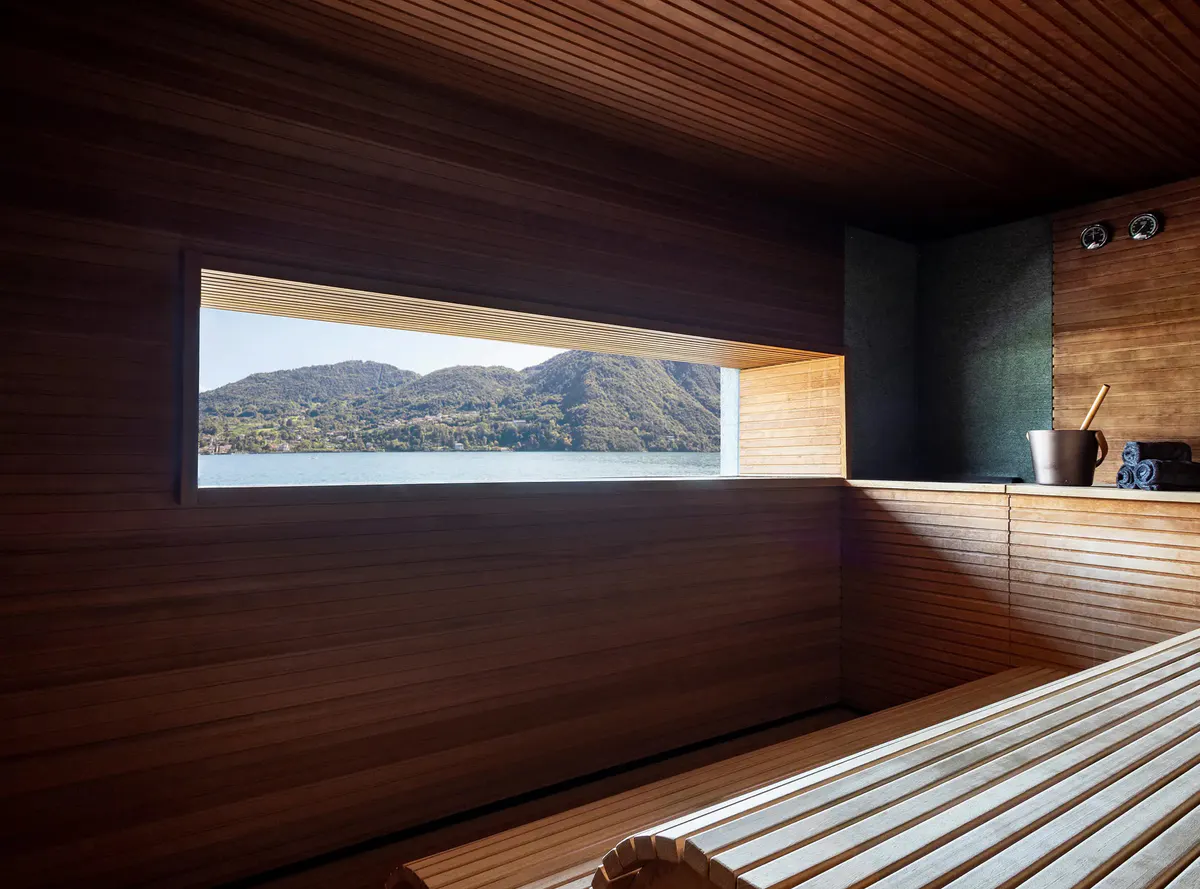Modern spa interior with wood walls and water feature facing lake views