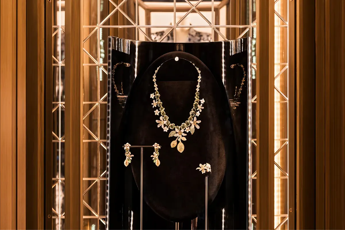 A jewelry display featuring an ornate gold necklace with matching earrings