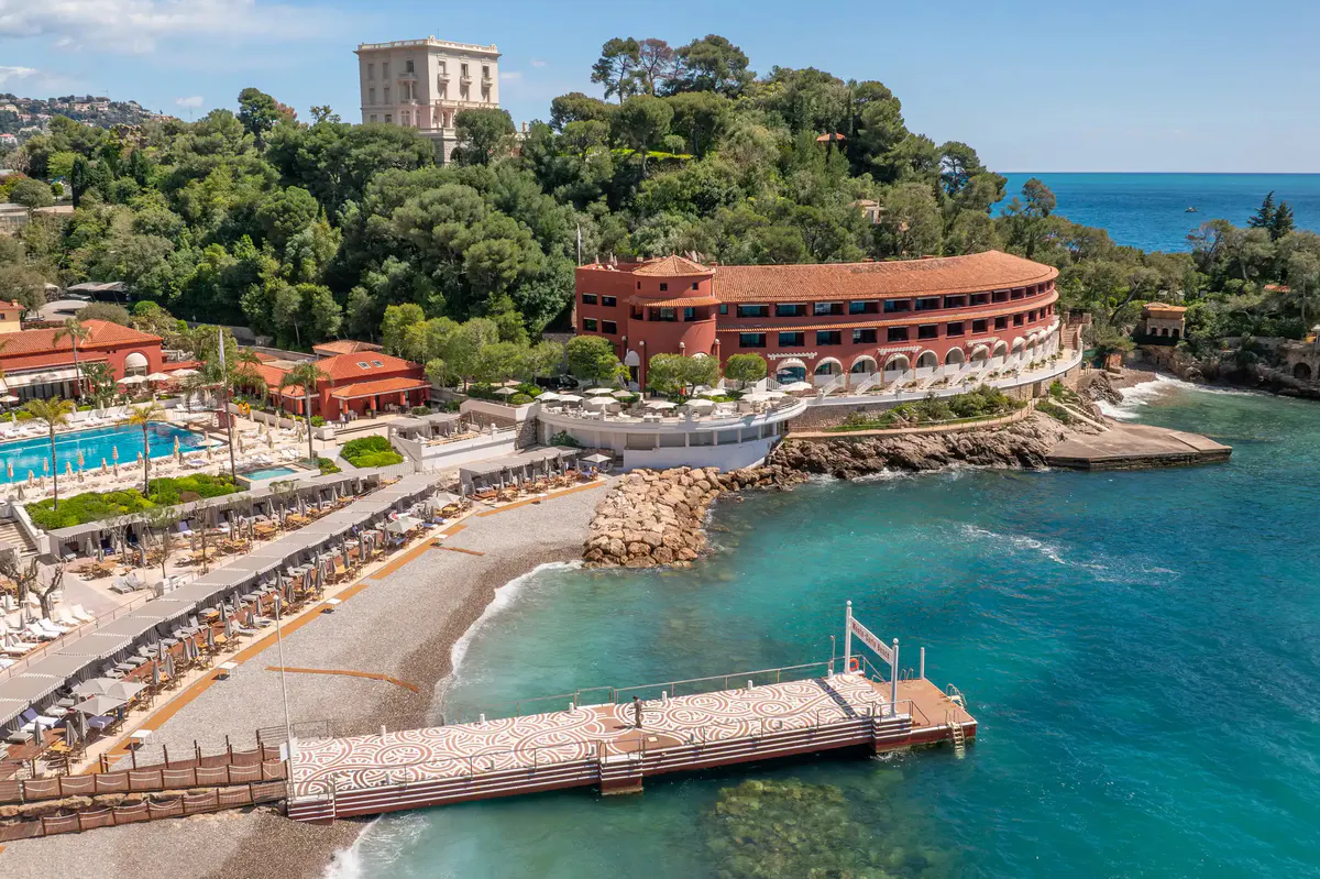 Coastal resort and spa facilities with red-roofed buildings and boat pier