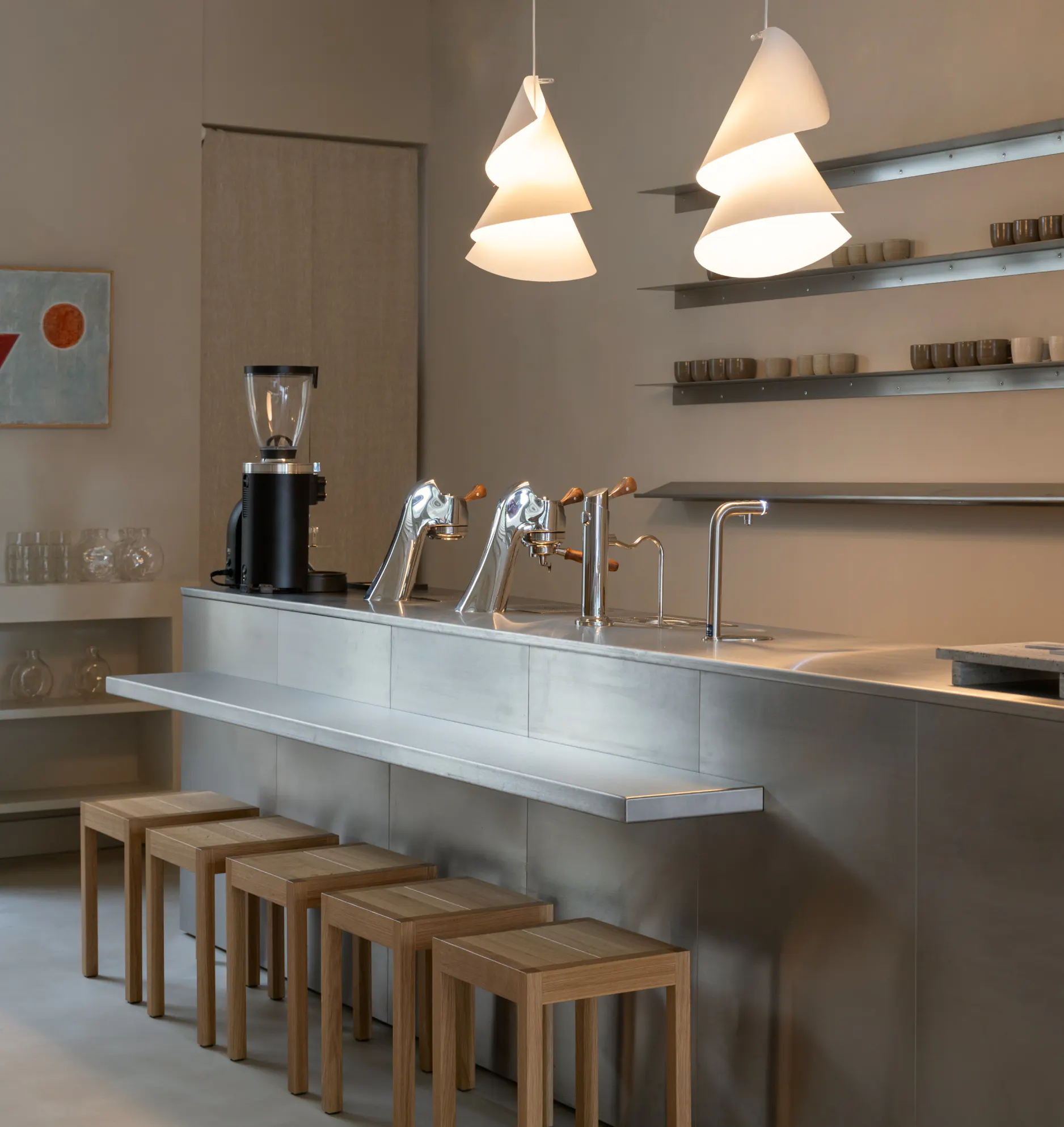 The steel counter and sculptural pendant lights at Two Story in Amsterdam