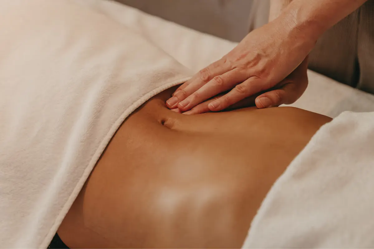 Hands performing massage therapy on client back