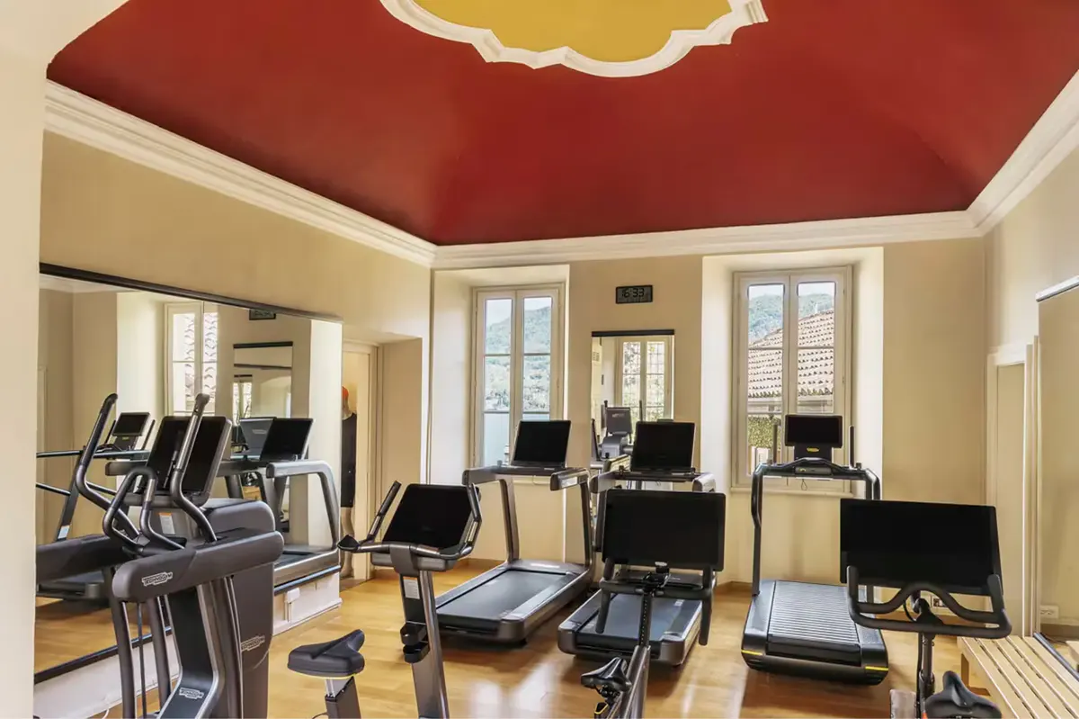 Fitness studio with exercise equipment and tall windows