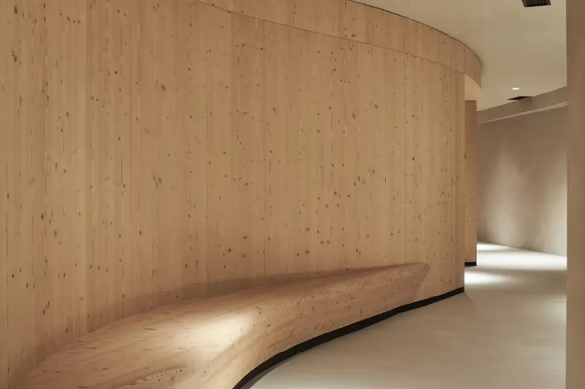 A spa preparation area with light wood and concrete, a functional sink counter, and neutral tones