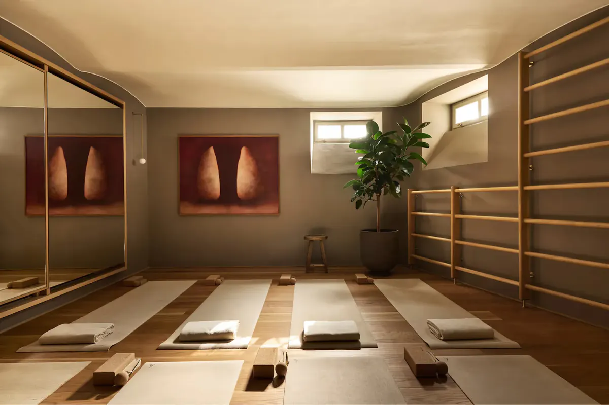 A spa hammam room with heated platforms, arched niches, and indirect lighting