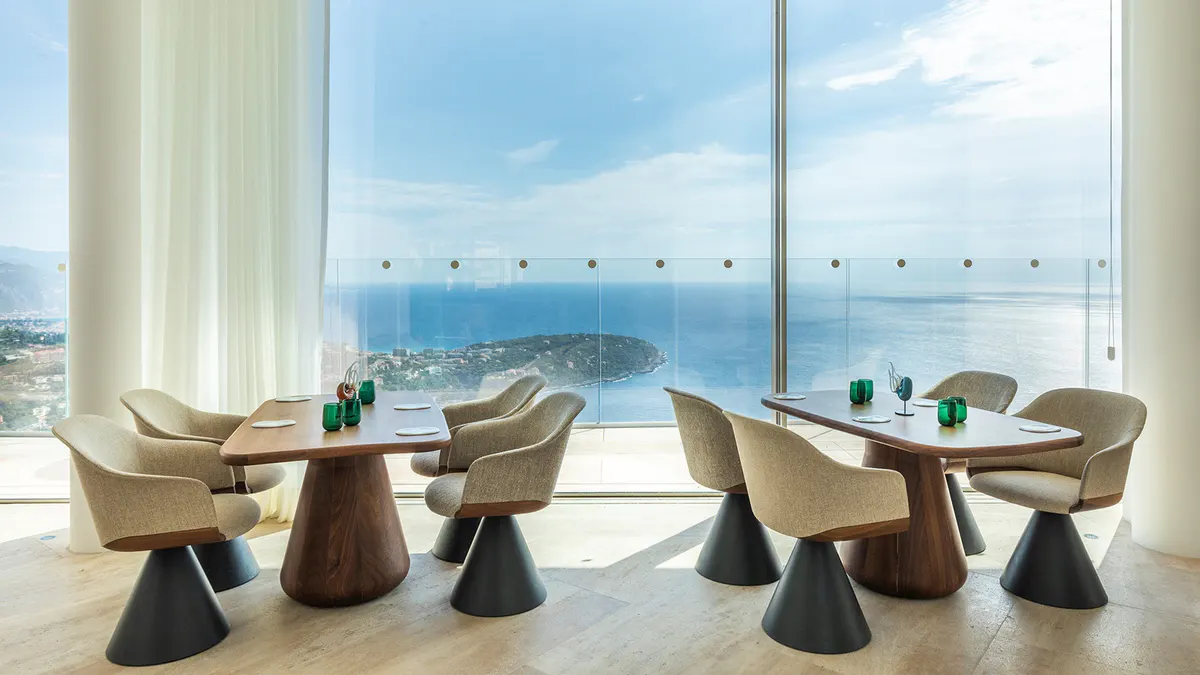 Dining lounge with blue chairs and sea view
