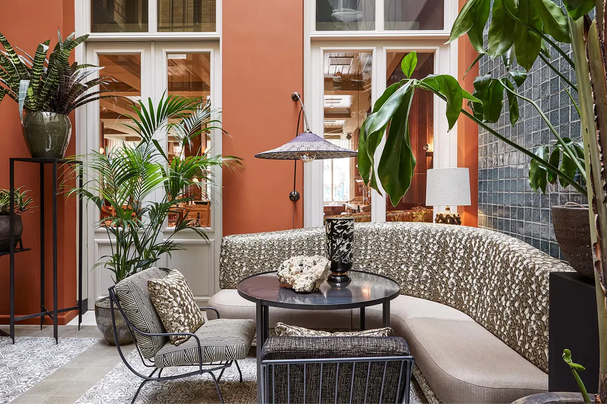 Outdoor patio with terracotta accents, potted plants, and modern furnishings