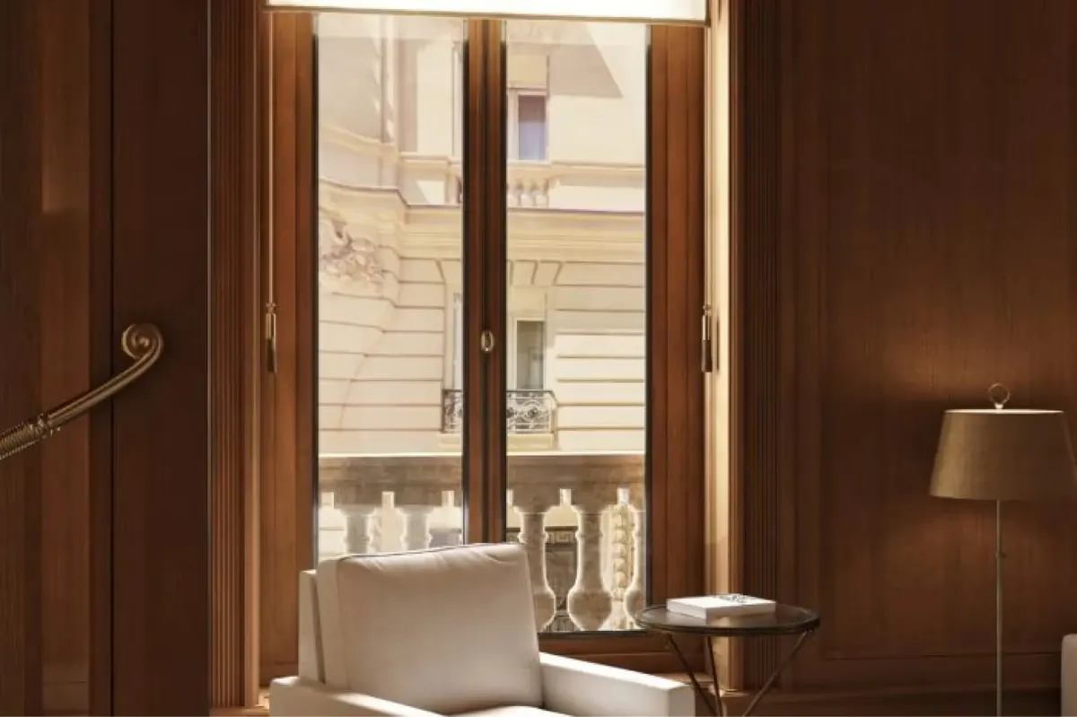 A spa room with warm wood tones, a bed, and modern fixtures