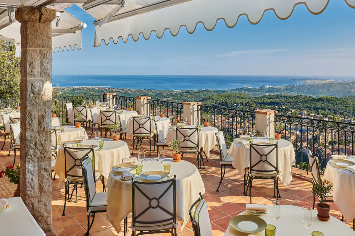 Terrace dining table with panoramic coastal and countryside views
