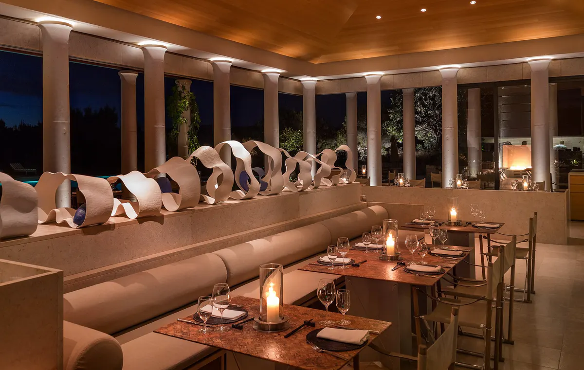 Modern dining room with curved banquette seating and ambient lighting