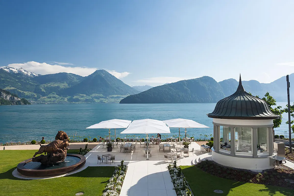 Manicured lawn with architectural gazebo and Alpine mountain vista