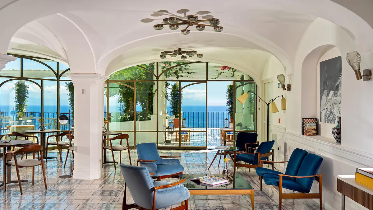 Light-filled lounge with columns, arched ceilings, and views to the seascape