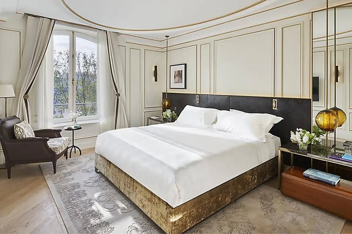 Bedroom with black-framed bed, draped windows, and curved architectural details