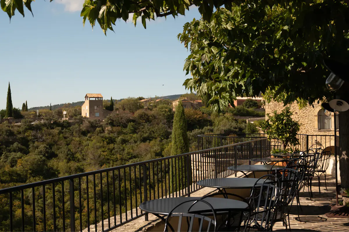 Dining terrace overlooking the Gordes landscape at golden hour