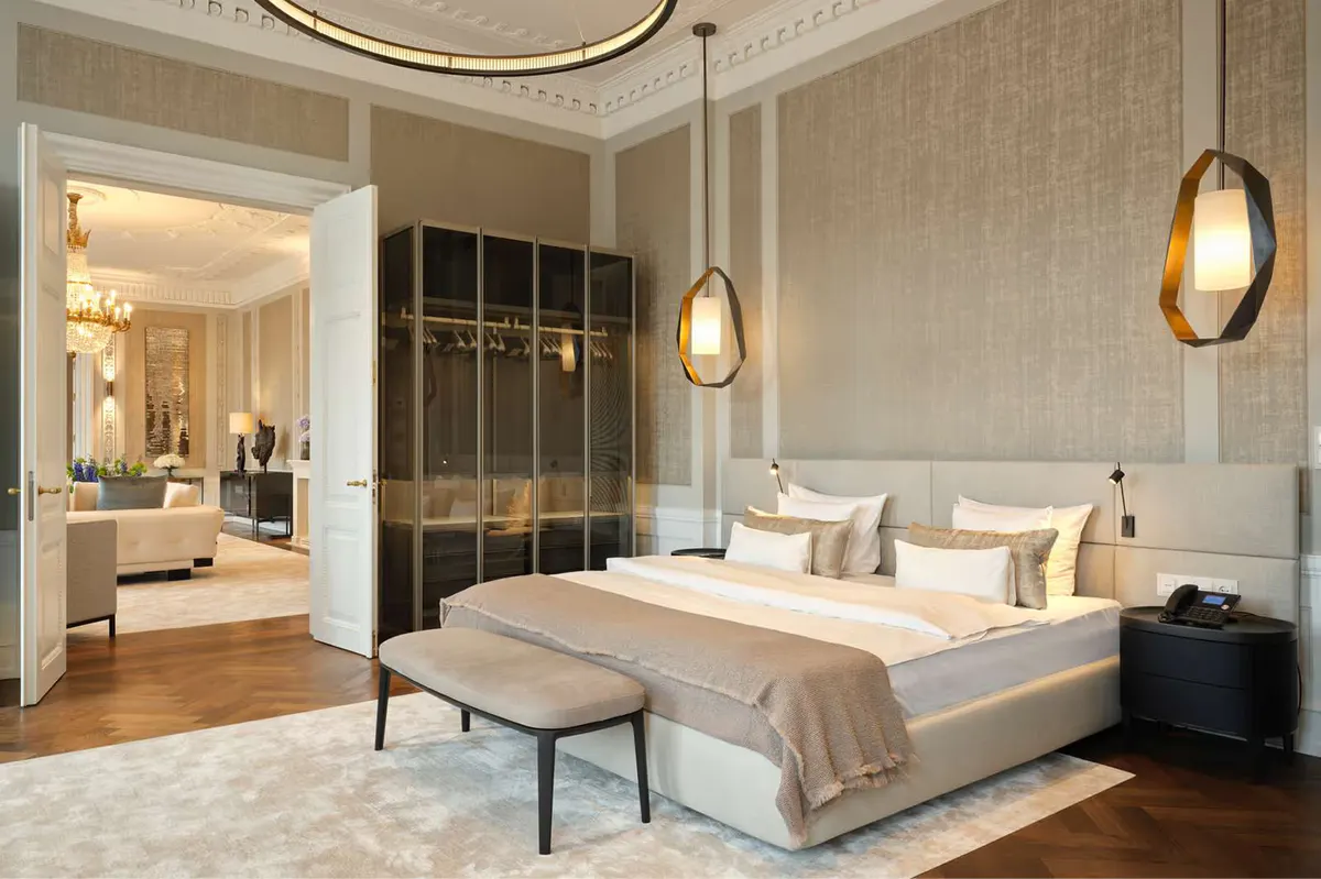 A suite bedroom with smoked oak furnishings and brass pendant lights