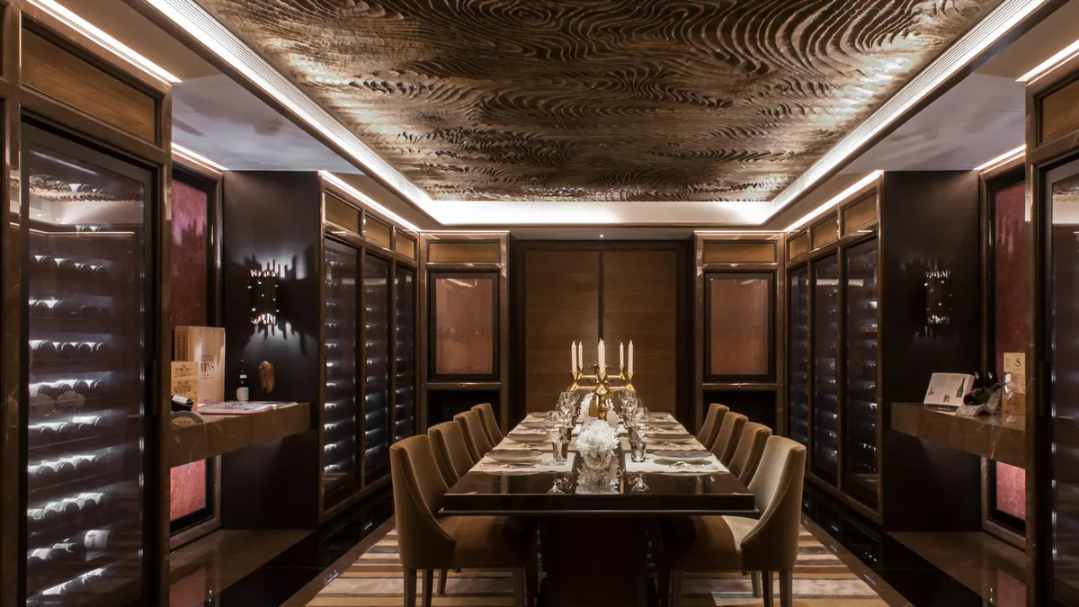 Intimate dining room with dark wood walls and elegant table settings